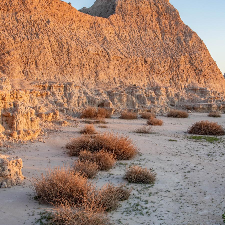 The last bit of sunlight turning the Badlands formation is orange.